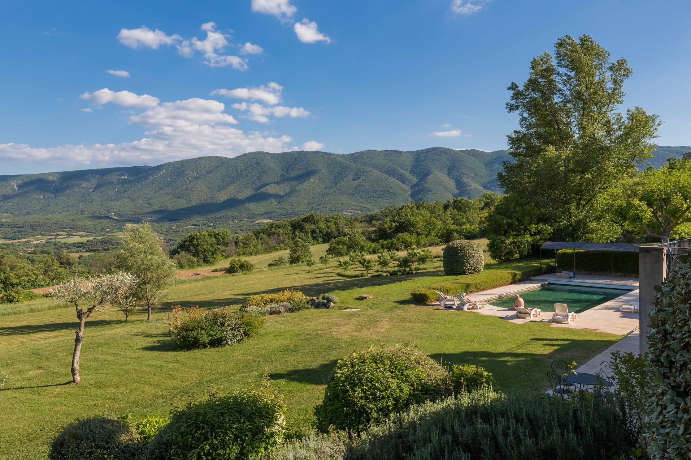View across the garden and pool to the Luberon hills